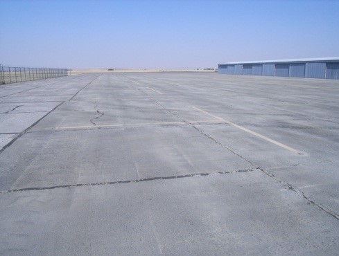 This picture shows an overview photo of a PCC pavement with visible joint spalling and slab cracking.  The PCI of the pavement in the image is 60.